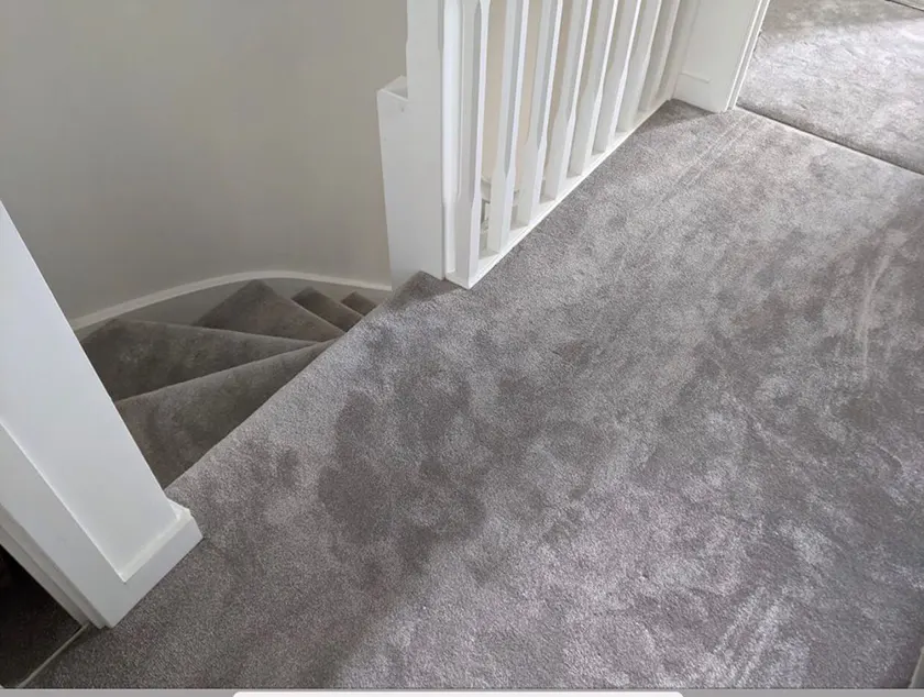 Gray carpet at the top of stairs